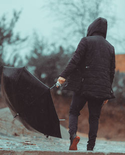 Rear view of man in sea during winter