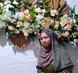 Young woman looking at flower bouquet