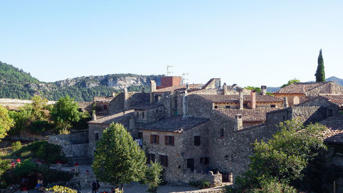 Buildings in city against clear sky