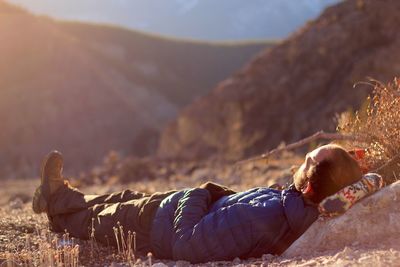 Low section of man lying on mountain