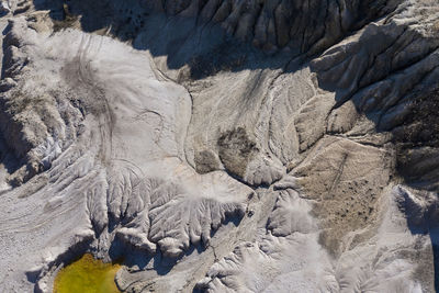Aerial shot of abandoned opencast mine. abstract cracked mud pattern, erosion, bad land