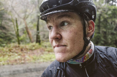 Close-up of man wearing cycling helmet and standing at street