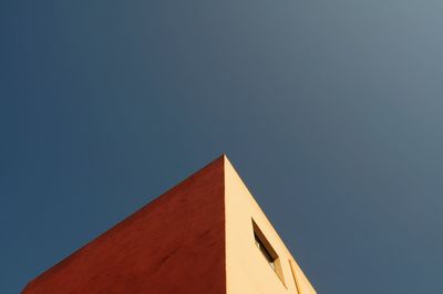 Low angle view of built structure against clear blue sky