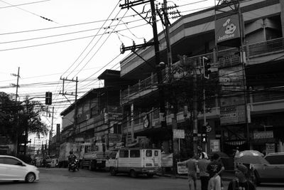 Cars on road against sky in city