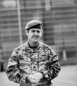 Portrait of smiling soldier standing outdoors