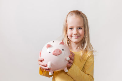 Portrait of smiling girl against white background