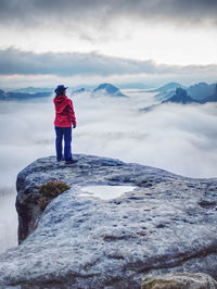 Woman watching sunrise over himalayas, misty mountains national park