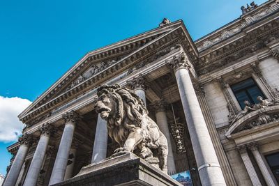 Low angle view of statue an building