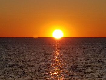 Scenic view of sea against orange sky