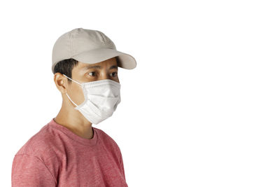 Portrait of man wearing mask against white background