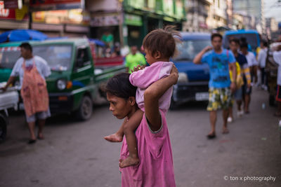 Rear view of people standing on street