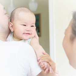 Close-up of baby daughter eith parents at home