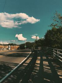 Railroad tracks in city against sky