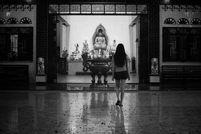 Rear view of woman walking in temple