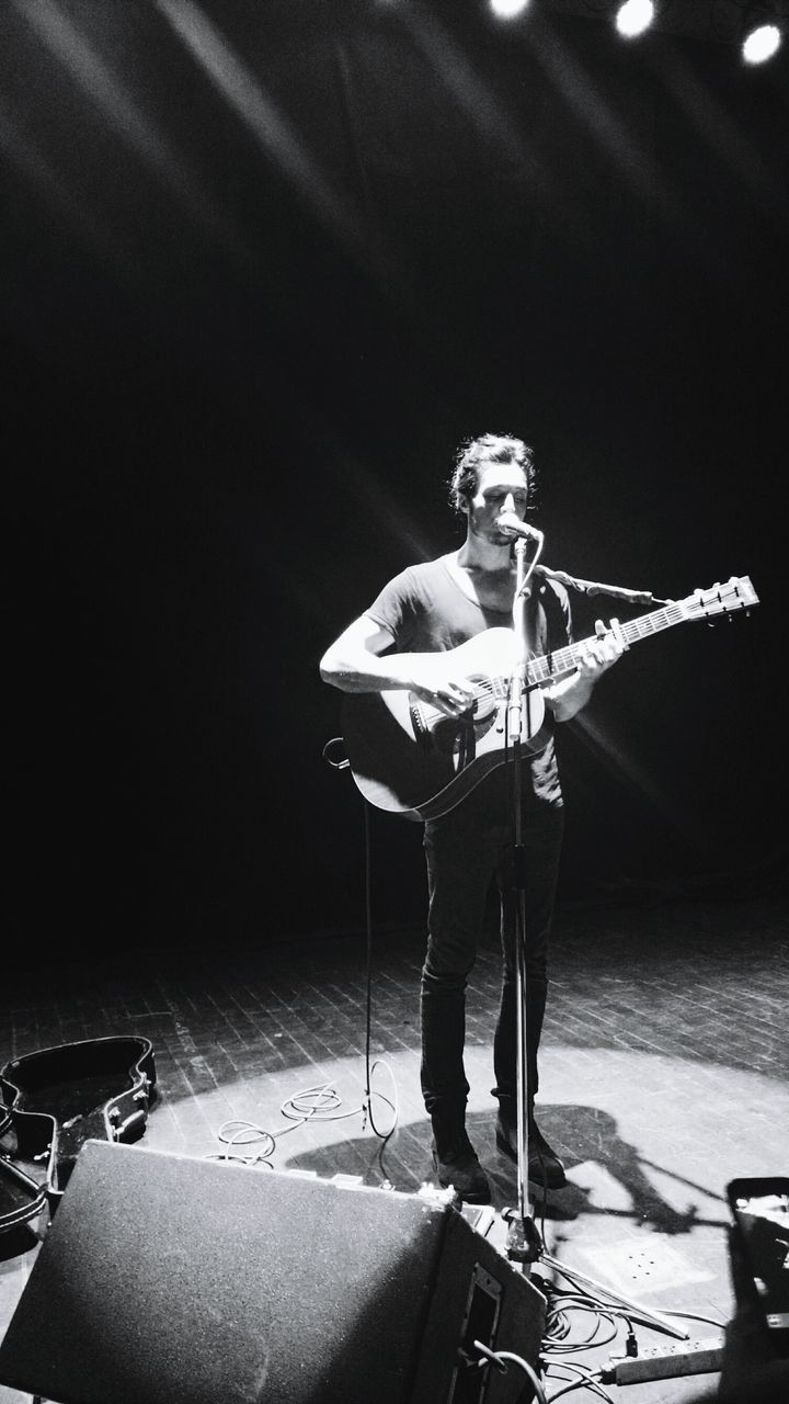 indoors, shadow, full length, musical instrument, chair, night, table, occupation, still life, holding, music, wall - building feature, hanging, skill, guitar, focus on foreground, men, sunlight