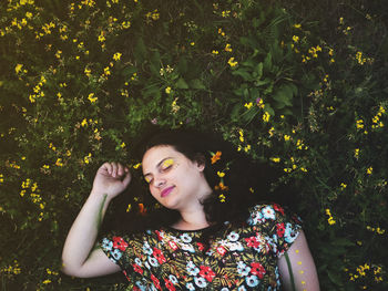 Young woman looking at flower tree