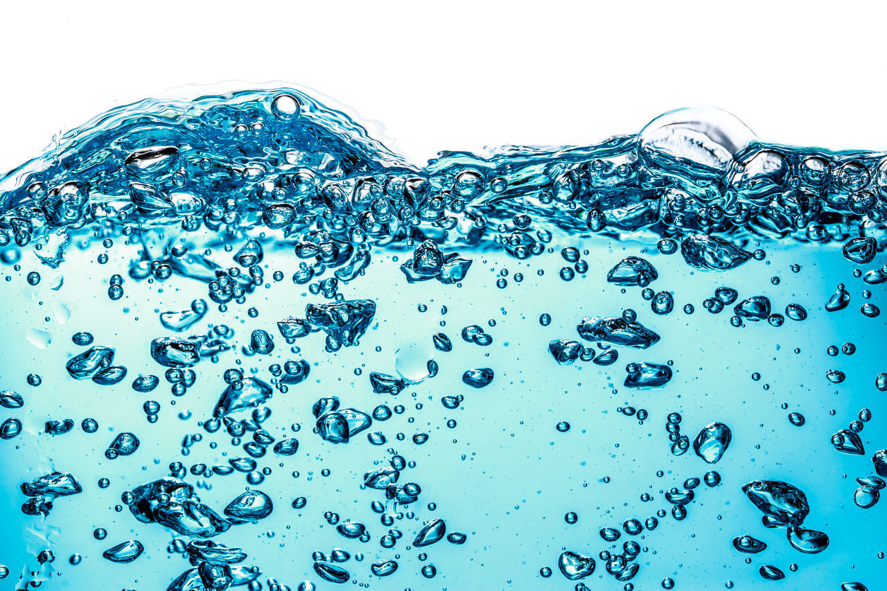 CLOSE-UP OF BUBBLES AGAINST SEA