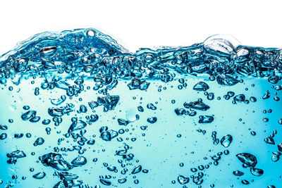 Close-up of bubbles against blue background