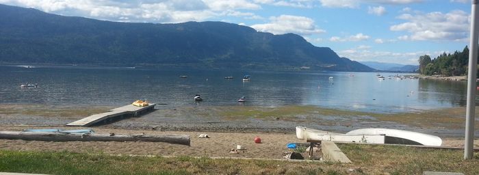 View of birds perching on lake against mountains