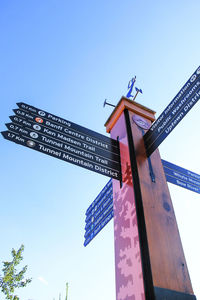 Low angle view of windmill against blue sky