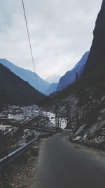 Road amidst snowcapped mountains against sky