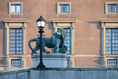 Statue against building in city