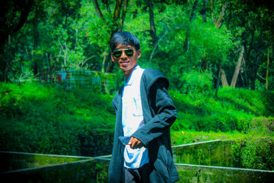 Portrait of smiling young man in forest