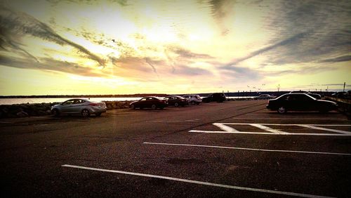 Road against cloudy sky at sunset