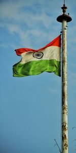 Low angle view of indian flag against blue sky