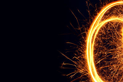 Wire wool spinning against black background