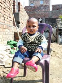 Portrait of boy sitting outdoors