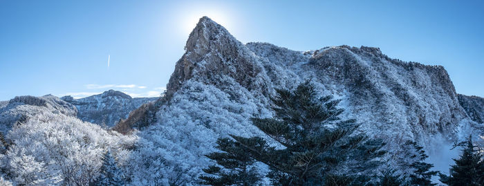 Low angle view of snowcapped mountain against sky