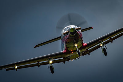 Low angle view of airplane flying against clear sky