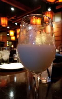 Close-up of wine in glass on table at night