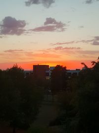 Silhouette buildings against sky during sunset