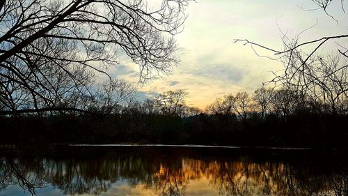 Scenic view of lake against sky at sunset