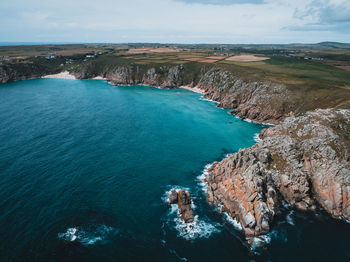 High angle view of rocks by sea against sky