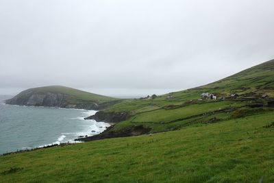 Scenic view of landscape and sea against sky