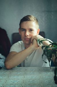 Portrait of young man lying on bed at home