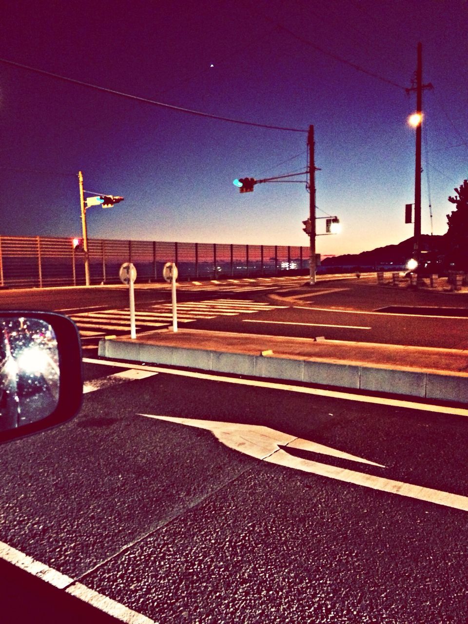 street light, transportation, road, the way forward, road marking, street, sky, lighting equipment, illuminated, road sign, car, asphalt, guidance, night, empty, diminishing perspective, mode of transport, vanishing point, land vehicle, outdoors