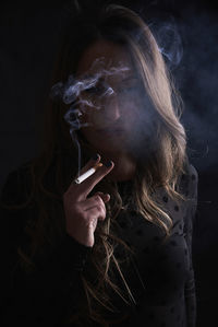 Midsection of woman smoking