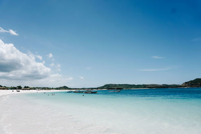 Scenic view of beach against blue sky