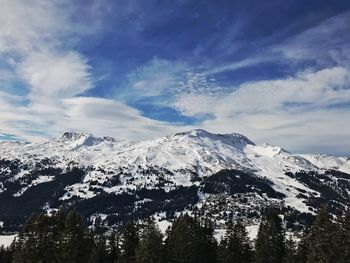 Low angle view of snowcapped mountains against sky