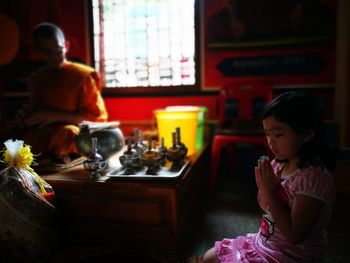 Cute little girl praying in temple