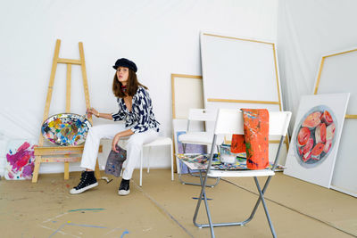 Young female artist in her painting studio