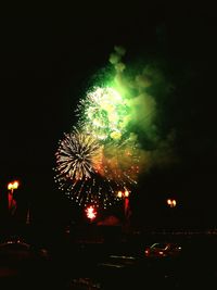 Low angle view of firework display at night