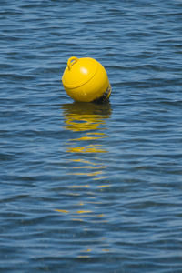 Yellow buoy in water