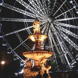 Low angle view of illuminated ferris wheel at night