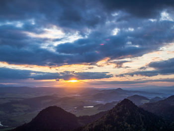 Scenic view of dramatic sky over landscape during sunset