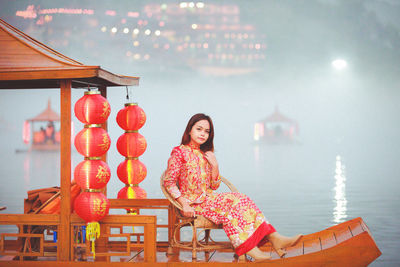 Asian woman wearing cheongsam traditional red dress on chinese new year travel.